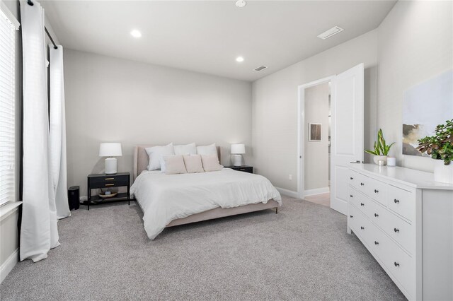 bedroom with baseboards, recessed lighting, visible vents, and light carpet