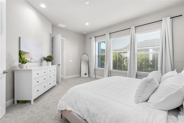 bedroom with recessed lighting, light colored carpet, and baseboards