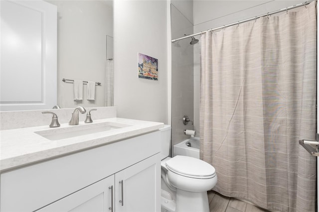 full bathroom with vanity, shower / tub combo, and toilet