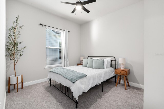 bedroom with baseboards, carpet floors, and ceiling fan