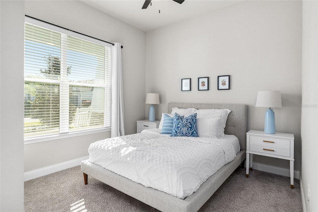 carpeted bedroom with baseboards and ceiling fan