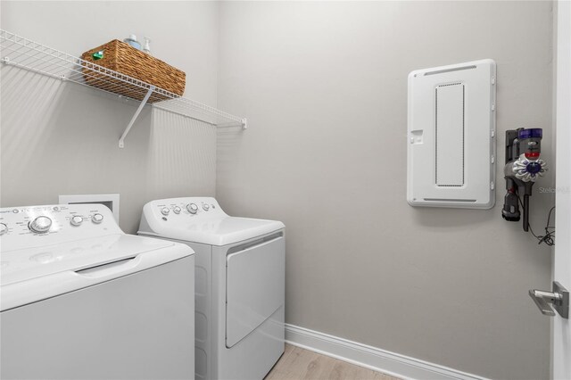 laundry room with washer and dryer, laundry area, light wood-style floors, and baseboards