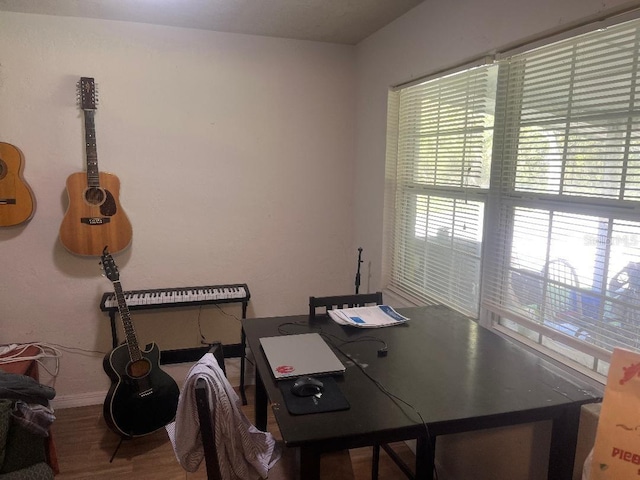 office space featuring baseboards and wood finished floors