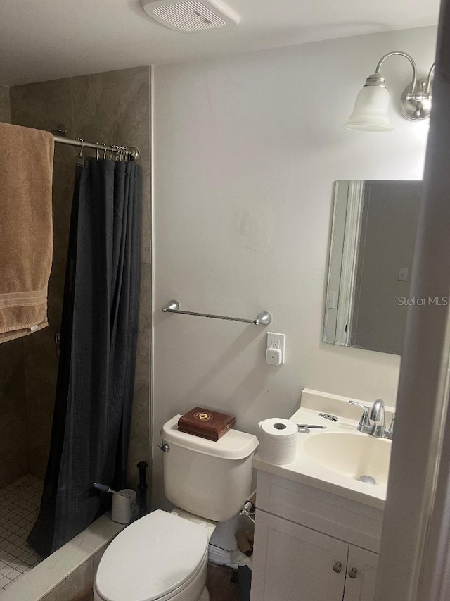 bathroom featuring vanity, a shower stall, toilet, and visible vents