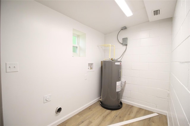 utility room featuring visible vents and water heater