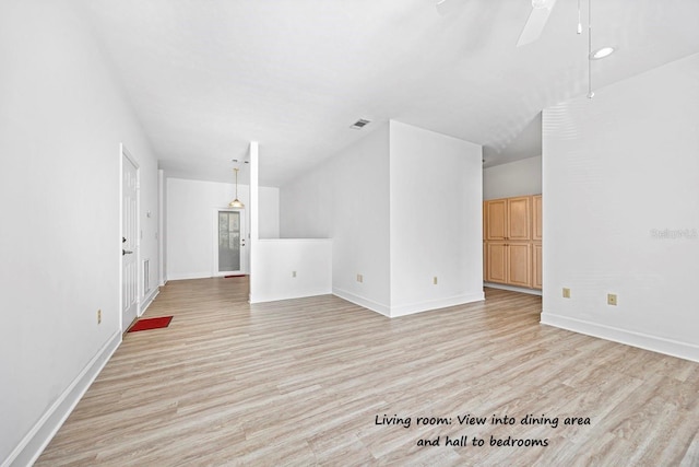 unfurnished living room featuring visible vents, light wood-style flooring, a ceiling fan, and baseboards