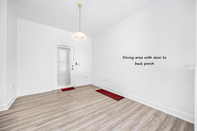 interior space with baseboards and wood finished floors