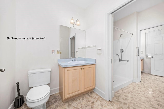 full bath featuring baseboards, vanity, a shower stall, and toilet