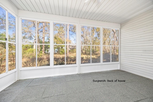 unfurnished sunroom with wood ceiling