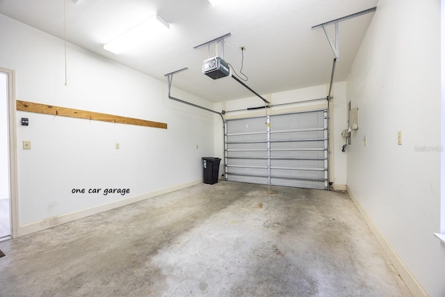 garage with a garage door opener and baseboards