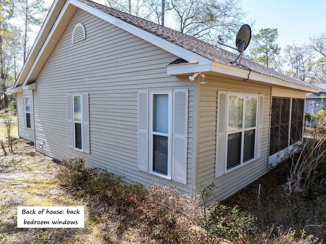 view of home's exterior with roof with shingles