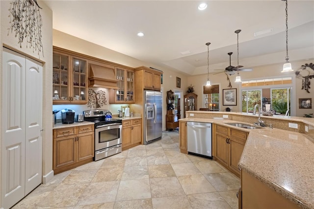 kitchen featuring hanging light fixtures, recessed lighting, custom exhaust hood, stainless steel appliances, and a sink