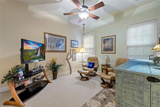 sitting room with a ceiling fan, baseboards, and carpet floors