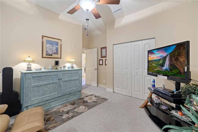 carpeted bedroom with visible vents, ceiling fan, baseboards, a towering ceiling, and a closet