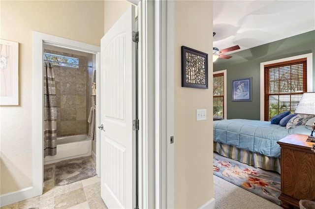 interior space with baseboards and ensuite bathroom