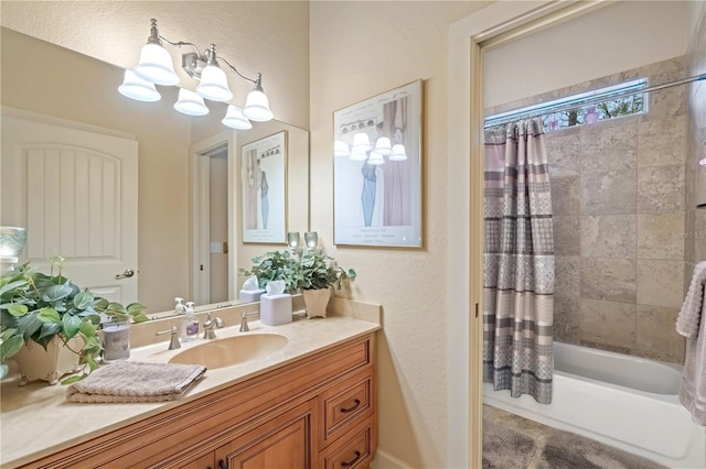 bathroom featuring a notable chandelier, shower / tub combo with curtain, and vanity