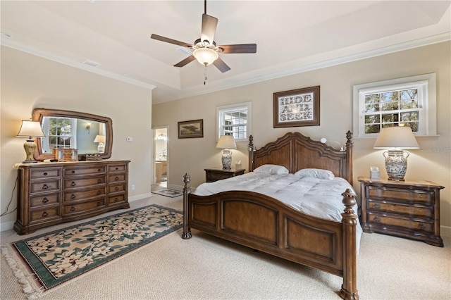 bedroom featuring light carpet, a raised ceiling, and ornamental molding