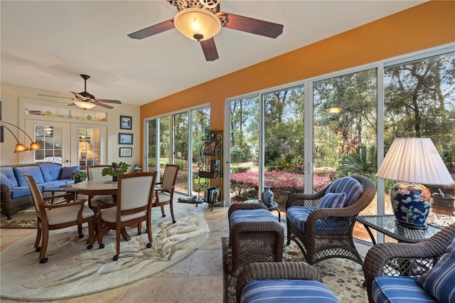 sunroom / solarium featuring french doors and ceiling fan