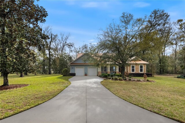 ranch-style house featuring a chimney, driveway, an attached garage, and a front lawn