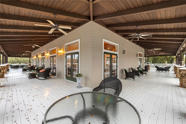 deck with ceiling fan, french doors, and outdoor dining space