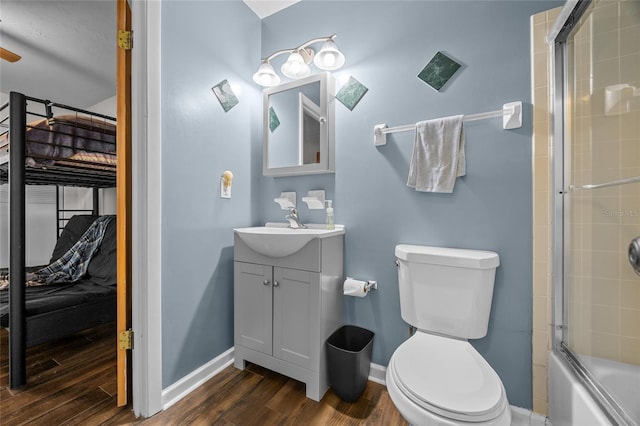 bathroom featuring toilet, baseboards, and wood finished floors