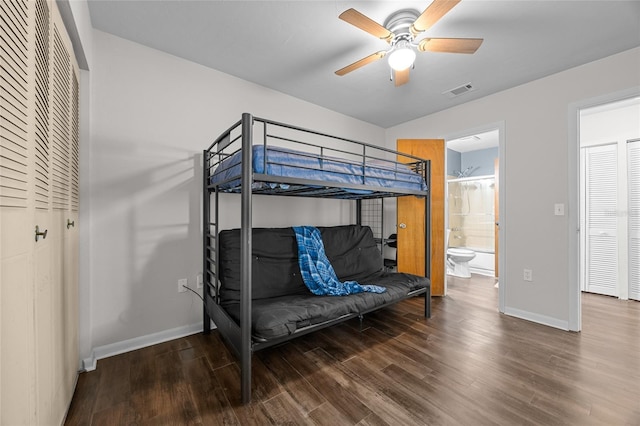 bedroom featuring connected bathroom, wood finished floors, visible vents, and baseboards