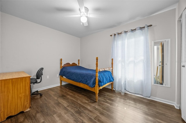 bedroom with baseboards, wood finished floors, and a ceiling fan