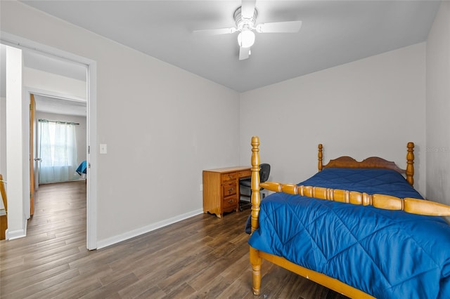 bedroom with a ceiling fan, baseboards, and wood finished floors