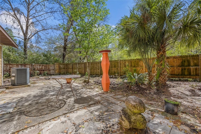 view of patio with cooling unit and a fenced backyard