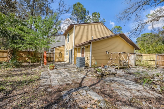 back of house featuring cooling unit, a patio, and a fenced backyard