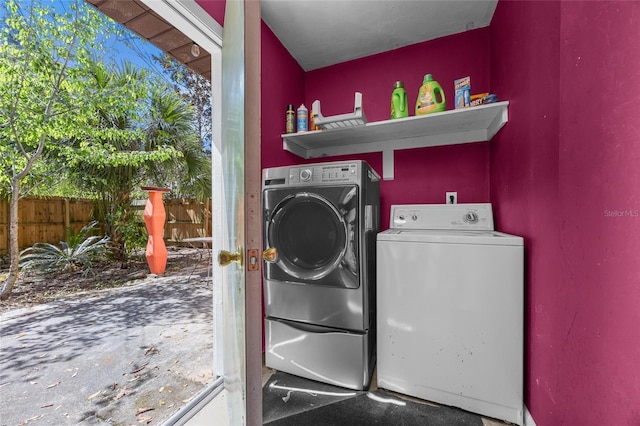 clothes washing area featuring laundry area and washing machine and clothes dryer