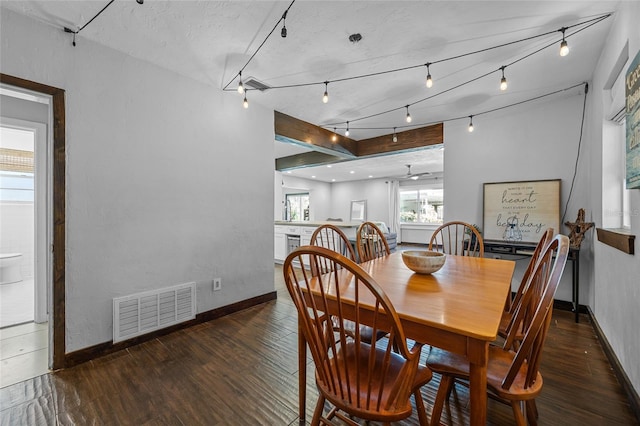 dining room with visible vents, baseboards, and wood finished floors