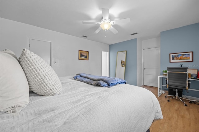 bedroom with ceiling fan, visible vents, a closet, and light wood-style flooring