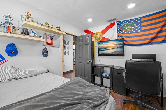 bedroom with recessed lighting, wood finished floors, and visible vents