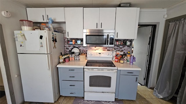 kitchen featuring white appliances, gray cabinetry, tile patterned flooring, light countertops, and white cabinets