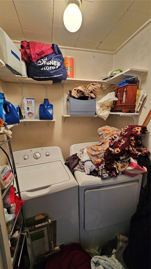 washroom featuring laundry area and washing machine and clothes dryer