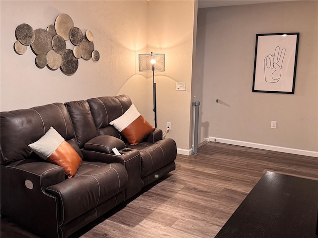 living area featuring baseboards and wood finished floors