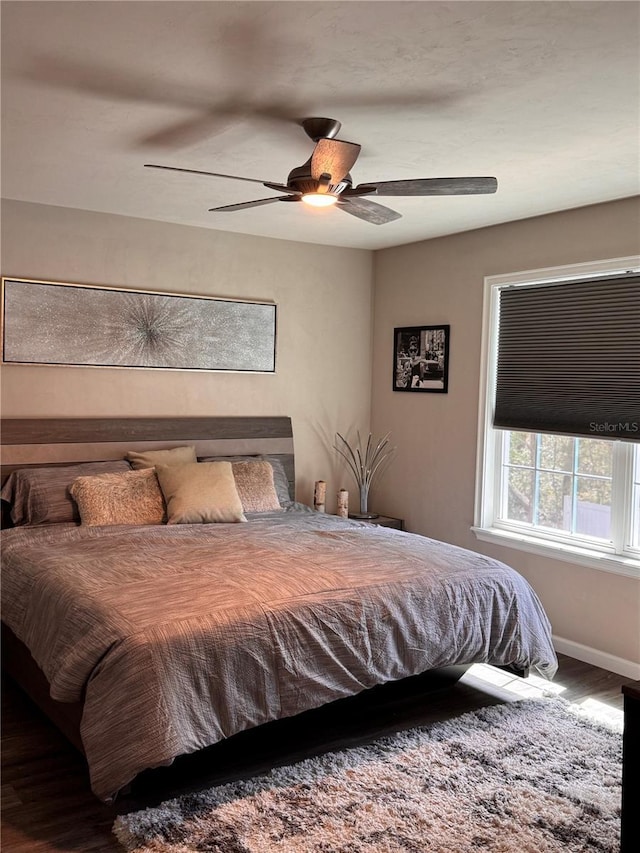 bedroom featuring a ceiling fan and baseboards