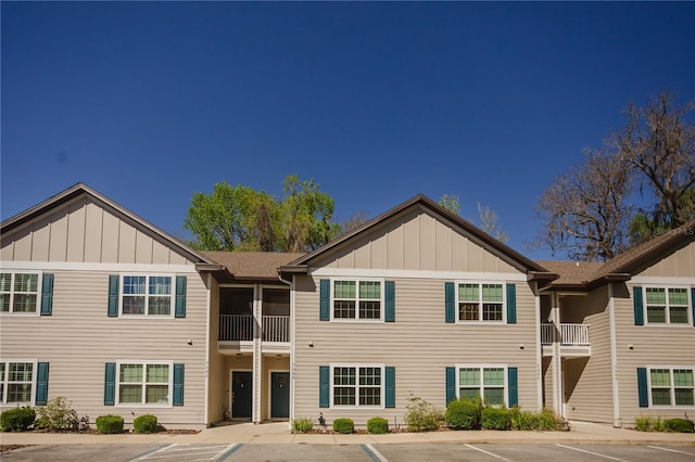 multi unit property with board and batten siding and uncovered parking