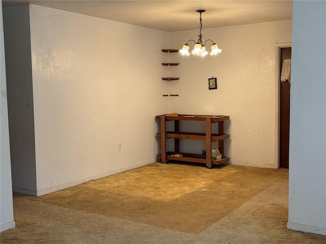 unfurnished dining area featuring baseboards, carpet, and an inviting chandelier