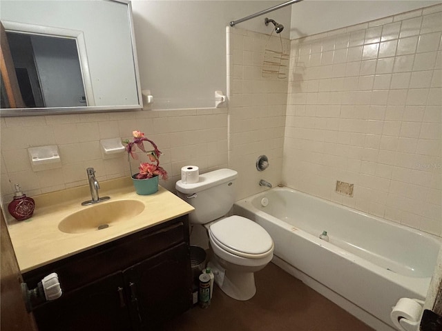 bathroom featuring toilet, tile walls, wainscoting, bathtub / shower combination, and vanity