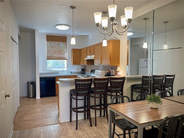 kitchen with electric range, under cabinet range hood, a sink, black dishwasher, and freestanding refrigerator