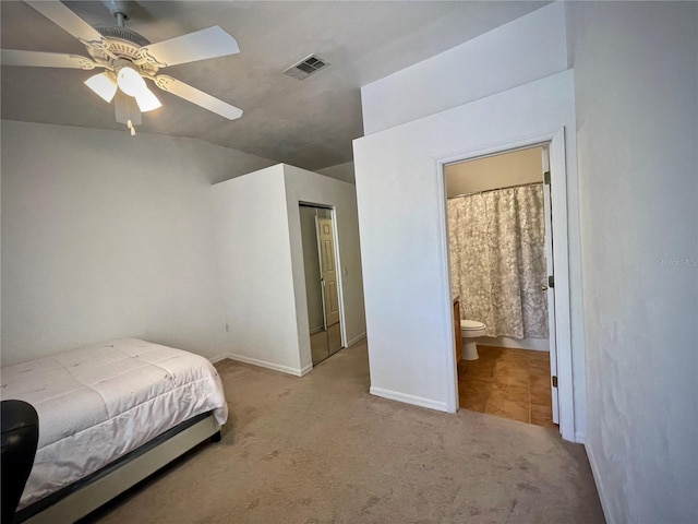 bedroom featuring ceiling fan, visible vents, carpet, and connected bathroom