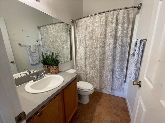 bathroom with vanity, tile patterned floors, toilet, and shower / bath combo with shower curtain