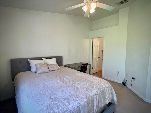 carpeted bedroom with visible vents, a ceiling fan, and baseboards