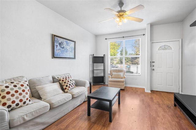 living area with wood finished floors, baseboards, and ceiling fan