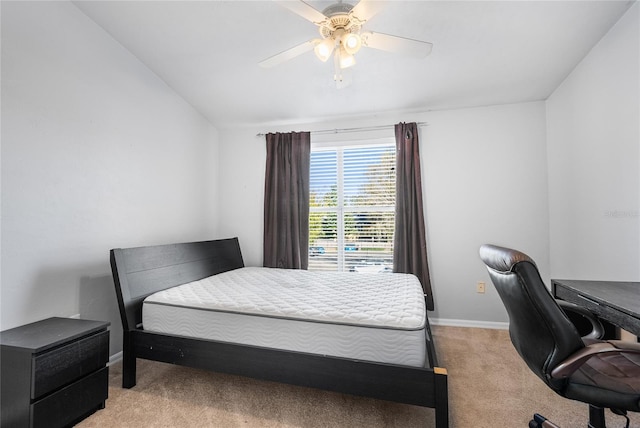 bedroom with vaulted ceiling, light colored carpet, baseboards, and ceiling fan