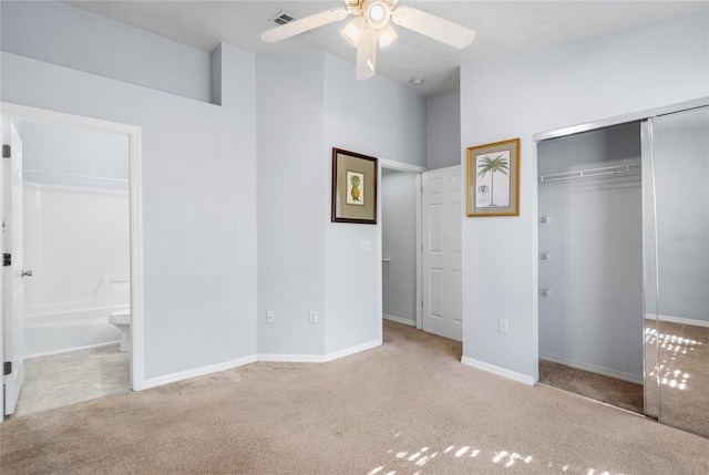 unfurnished bedroom with visible vents, ensuite bath, a closet, carpet floors, and baseboards