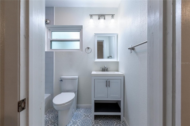 bathroom with tile patterned floors, toilet, vanity, and baseboards