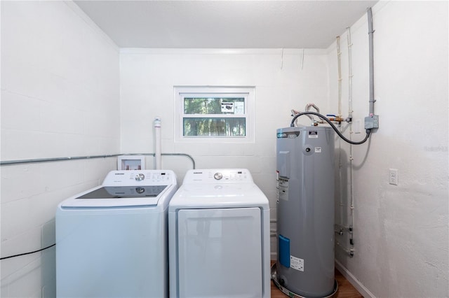 clothes washing area with water heater, laundry area, independent washer and dryer, and concrete block wall